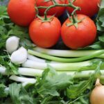 Image of fresh tomatoes, onions, greens, and other vegetables.